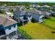 Aerial view of the home's backyard in a neighborhood with well-manicured lawns and pools at 8262 Velda Trl, Sarasota, FL 34241