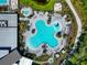 Aerial view showcasing a unique flower-shaped community pool and hot tub with ample lounge areas at 8262 Velda Trl, Sarasota, FL 34241