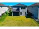 The backyard includes a screened in porch, a lawn, and is surrounded by neighboring homes at 8262 Velda Trl, Sarasota, FL 34241