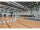 Well-lit indoor basketball court with multiple hoops and a polished wooden floor at 8262 Velda Trl, Sarasota, FL 34241