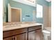 The bathroom features a double sink vanity, a large mirror, and a separate bath and toilet at 8262 Velda Trl, Sarasota, FL 34241