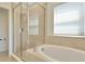 Elegant bathroom with soaking tub and glass enclosed shower stall at 8262 Velda Trl, Sarasota, FL 34241