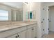 Bright bathroom featuring double sinks, vanity, and a glass door shower at 8262 Velda Trl, Sarasota, FL 34241