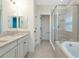 Modern bathroom with double sink vanity, soaking tub and glass shower at 8262 Velda Trl, Sarasota, FL 34241