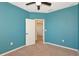 The bedroom features neutral carpet, an overhead fan, and a window for natural light at 8262 Velda Trl, Sarasota, FL 34241