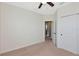Bedroom with neutral carpet, ceiling fan and closet doors leading to a bathroom at 8262 Velda Trl, Sarasota, FL 34241