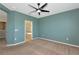 Bedroom with neutral carpet, ceiling fan, and connecting door to the bathroom at 8262 Velda Trl, Sarasota, FL 34241