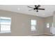 A bedroom features a ceiling fan, carpet floors, and windows with blinds at 8262 Velda Trl, Sarasota, FL 34241