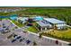 Aerial view of the community center featuring a pool, clubhouse, and parking at 8262 Velda Trl, Sarasota, FL 34241