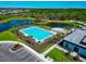Aerial view of the community pool surrounded by lush landscaping and lounge chairs at 8262 Velda Trl, Sarasota, FL 34241