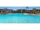 Stunning community pool with palm trees and plenty of lounge seating at 8262 Velda Trl, Sarasota, FL 34241