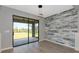 Dining area featuring hardwood floors, sliding glass doors to the yard, and a decorative accent wall at 8262 Velda Trl, Sarasota, FL 34241