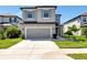 Charming two-story home features a spacious driveway and an attached two-car garage at 8262 Velda Trl, Sarasota, FL 34241