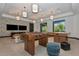 Spacious game room featuring foosball table, air hockey and lounging area with two TVs and stylish decor at 8262 Velda Trl, Sarasota, FL 34241
