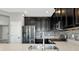 Modern kitchen featuring stainless steel appliances, dark cabinets, and quartz countertops at 8262 Velda Trl, Sarasota, FL 34241