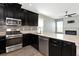Kitchen showcasing stainless appliances and view into the living room with a fireplace at 8262 Velda Trl, Sarasota, FL 34241