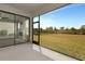 Spacious lanai area leading to a grassy backyard and featuring exterior sliding glass doors at 8262 Velda Trl, Sarasota, FL 34241