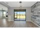 Living area featuring gray walls, modern flooring, and sliding glass doors to the outside at 8262 Velda Trl, Sarasota, FL 34241