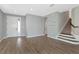 Spacious living room featuring gray walls, wood floors, and a stairway at 8262 Velda Trl, Sarasota, FL 34241
