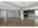 Spacious living area with hardwood floors, staircase, and open concept kitchen with stainless steel appliances at 8262 Velda Trl, Sarasota, FL 34241