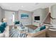 Bright living room featuring hardwood floors, beach themed decorations, and comfortable wicker furniture at 8262 Velda Trl, Sarasota, FL 34241