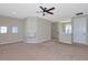 The carpeted loft offers ample space and natural light, with a ceiling fan and bright walls at 8262 Velda Trl, Sarasota, FL 34241
