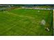 Aerial view of a meticulously maintained grass soccer field, complete with goals, in a vibrant community at 8262 Velda Trl, Sarasota, FL 34241