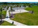 Aerial shot of a sand volleyball court in a community, complemented by lush green grass and scenic surroundings at 8262 Velda Trl, Sarasota, FL 34241