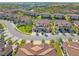 Aerial view of real estate with well-manicured lawns, mature trees and landscaping at 8323 Enclave Way # 104, Sarasota, FL 34243