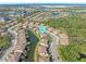 Aerial view showcases the community layout and proximity to ponds and serene landscapes at 8323 Enclave Way # 104, Sarasota, FL 34243