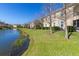 Beautiful backyard with a serene pond view that offers a peaceful escape at 8323 Enclave Way # 104, Sarasota, FL 34243