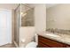 Cozy bathroom featuring a shower with glass door and a granite vanity top at 8323 Enclave Way # 104, Sarasota, FL 34243