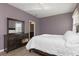 Cozy bedroom with wood-look flooring and furniture with a view to the Primary bath at 8323 Enclave Way # 104, Sarasota, FL 34243