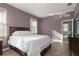 Bedroom with wood-look floors, natural light and a view to the ensuite bath at 8323 Enclave Way # 104, Sarasota, FL 34243