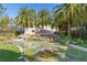 Picturesque community entrance featuring lush landscaping and a tranquil water feature at 8323 Enclave Way # 104, Sarasota, FL 34243