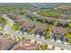 Aerial view featuring a well-planned community with tree-lined streets, waterways, and manicured lawns at 8323 Enclave Way # 104, Sarasota, FL 34243