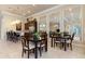 This dining area features modern decor, a table set for four, and stylish barstool seating at the kitchen island at 8323 Enclave Way # 104, Sarasota, FL 34243