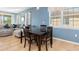 Dining room has tile floor, blue accent wall, and a comfortable sofa at 8323 Enclave Way # 104, Sarasota, FL 34243
