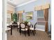 Community dining room featuring tables with seating, window treatments, and decorations for resident gatherings at 8323 Enclave Way # 104, Sarasota, FL 34243