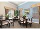 Community dining room with multiple tables and chairs, large windows, and tasteful decorations for residents at 8323 Enclave Way # 104, Sarasota, FL 34243