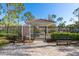 The Soleil dog park features a shaded gazebo, dog park rules, park benches, and decorative landscaping at 8323 Enclave Way # 104, Sarasota, FL 34243