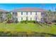 Exterior view from backyard with grass field in this well maintained community at 8323 Enclave Way # 104, Sarasota, FL 34243