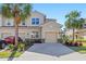Charming front exterior with a two-car garage and well-manicured landscaping at 8323 Enclave Way # 104, Sarasota, FL 34243