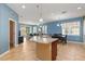 Open kitchen featuring granite countertops, stainless steel appliances, and seamless flow to the dining and living area at 8323 Enclave Way # 104, Sarasota, FL 34243