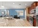 Modern kitchen featuring granite countertops, stainless steel appliances, and seamless flow to the living area at 8323 Enclave Way # 104, Sarasota, FL 34243