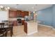 Open kitchen featuring granite countertops, stainless steel appliances, and seamless flow to the dining area at 8323 Enclave Way # 104, Sarasota, FL 34243