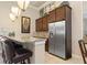 Kitchenette features granite countertops, a tile backsplash, dark wood cabinets, and stainless steel appliances at 8323 Enclave Way # 104, Sarasota, FL 34243