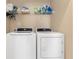 Convenient laundry room equipped with modern appliances and shelving at 8323 Enclave Way # 104, Sarasota, FL 34243