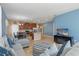 Spacious living room featuring contemporary decor, tile floors, and an open layout with a view of the kitchen at 8323 Enclave Way # 104, Sarasota, FL 34243