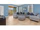 Comfortable living room with tile floors, modern furnishings, and sliding glass doors to screened in porch at 8323 Enclave Way # 104, Sarasota, FL 34243